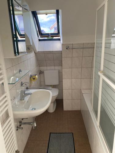 a bathroom with a sink and a toilet and a window at GünON Houses 19 in Linz