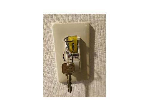 a key is attached to a wall at Smile Hotel Nagoya Shinkansenguchi - Vacation STAY 05091v in Nagoya