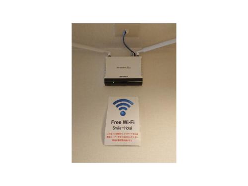 a free wifi sign on a wall in a room at Smile Hotel Nagoya Shinkansenguchi - Vacation STAY 05091v in Nagoya