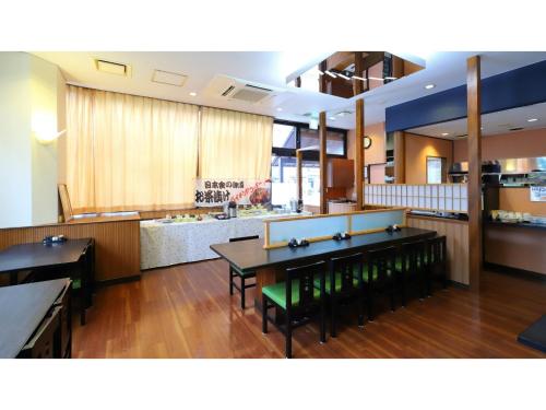 a room with tables and chairs in a kitchen at Smile Hotel Nagoya Shinkansenguchi - Vacation STAY 05091v in Nagoya