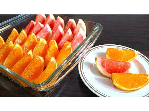 a tray of fruit on a table with a plate at Smile Hotel Okinawa Naha - Vacation STAY 04084v in Naha