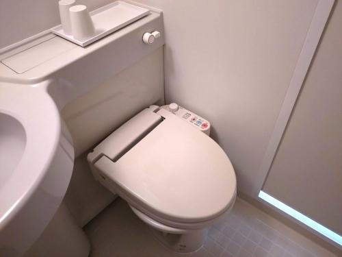 a bathroom with a white toilet and a sink at Smile Hotel Okinawa Naha - Vacation STAY 04084v in Naha