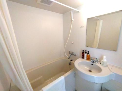 a bathroom with a sink and a bath tub at Smile Hotel Okinawa Naha - Vacation STAY 04084v in Naha