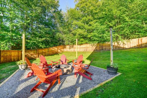 a group of chairs around a fire pit in a yard at West Branch Delaware River Cozy Cabin Retreat! in Deposit