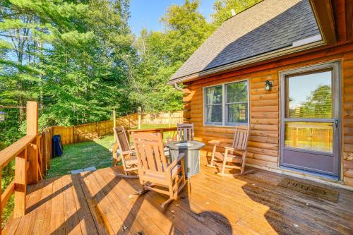 a cabin with chairs and a table on a deck at West Branch Delaware River Cozy Cabin Retreat! in Deposit
