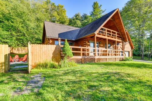 a large wooden house with a fence in the yard at West Branch Delaware River Cozy Cabin Retreat! in Deposit