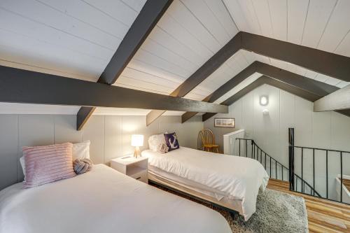 two beds in a room with a attic at 'Bear Crossing Chalet:' Beech Mountain Family Home in Beech Mountain