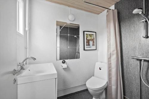 a white bathroom with a toilet and a sink at SB50628-Sydals-Egemose-131 in Skovmose