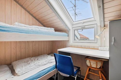 a small bedroom with a bunk bed and a blue chair at SB50389-Sydals-Harresbaek-20 in Sarup