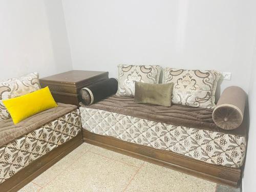a couch with pillows on it in a room at Msn in Rabat