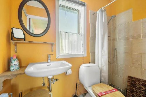 a bathroom with a sink and a toilet and a mirror at SB50626-Sydals-Egemose-157 in Skovmose