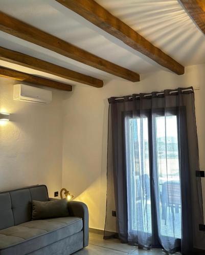 a living room with a couch and a large window at SOPHILIA SUITES in Koufonisia