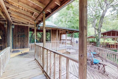 a wooden porch of a house with a deck at Creekside Casita in Schumannsville