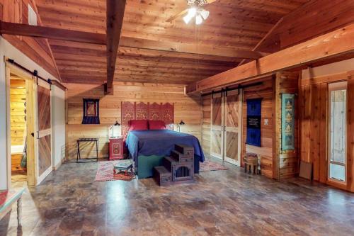 a bedroom with a bed in a wooden room at Creekside Casita in Schumannsville
