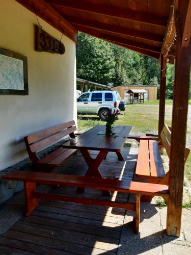 a picnic table and a bench on a porch at EkoTurystyka Natura Gwiazd - Green Velo - Workation Park - Ziołowy Klimat Bieszczad in Dubiecko