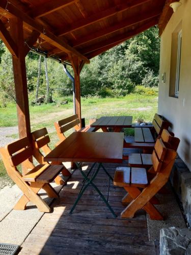 a picnic table and chairs on a patio at EkoTurystyka Natura Gwiazd - Green Velo - Workation Park - Ziołowy Klimat Bieszczad in Dubiecko