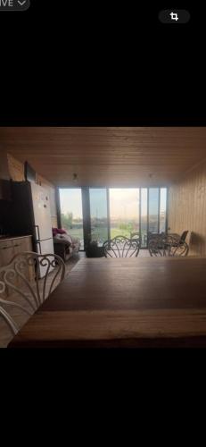 a group of chairs in a room with windows at Home in Yerevan