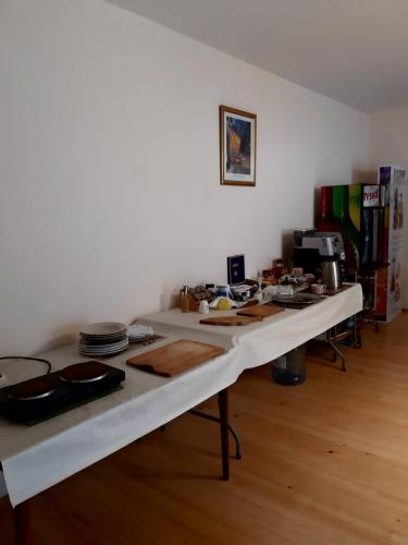 a long white table in a room with food on it at EkoTurystyka Natura Gwiazd - Green Velo - Workation Park - Ziołowy Klimat Bieszczad in Dubiecko