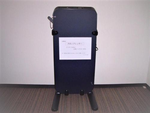 a black cell phone is sitting in a room at Smile Hotel Mito - Vacation STAY 99827v in Mito