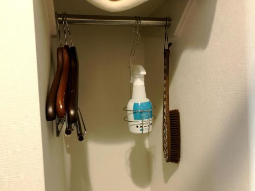 a rack with a hair brush and a bottle on a wall at Smile Hotel Mito - Vacation STAY 99827v in Mito