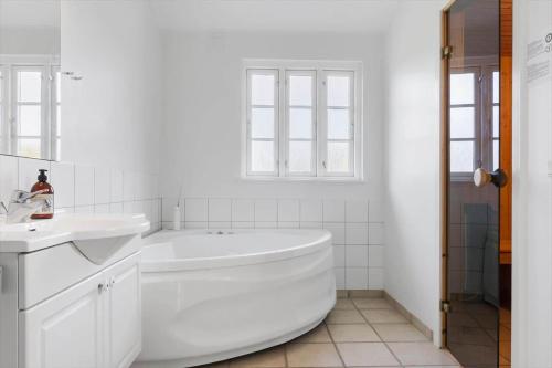 a white bathroom with a tub and a sink at SB109-Aabenraa-Golfsvinget-40 in Aabenraa