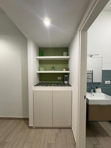 a kitchen with white cabinets and a sink at Alloggio Turistico Mare Verde Gaeta in Gaeta