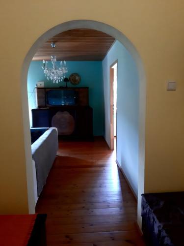 an archway leading to a living room with blue walls at EkoTurystyka Natura Gwiazd - Green Velo - Workation Park - Ziołowy Klimat Bieszczad in Dubiecko