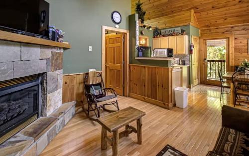 a living room with a fireplace in a log cabin at Best Value Cabin Hot Tub Arcade Close to Strip in Pigeon Forge