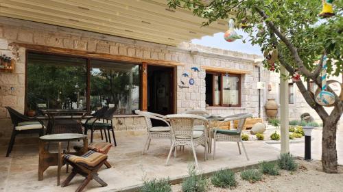 a patio with chairs and tables and a table at Yıldız Hotel in Urgup