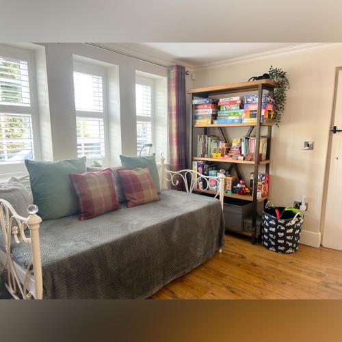 a bedroom with a bed and a book shelf at Peak District Period Property near Chatsworth House in Bakewell