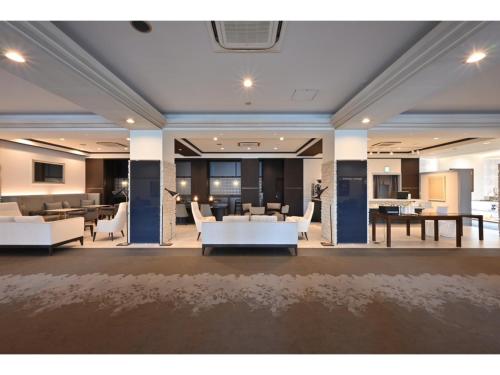 a large room with white chairs and tables at K,M,H Art hotel by Kure Morisawa - Vacation STAY 11399v in Kure