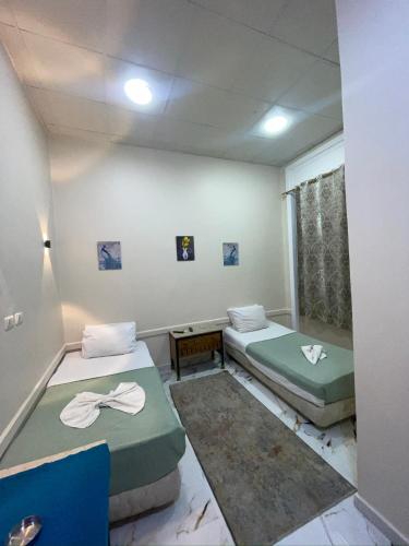 a room with two beds and a window at One Season Hotel in Cairo