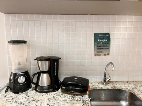 a kitchen counter with a blender and a sink at Lindo flat no Manaíra Apart Hotel in João Pessoa