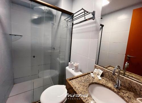 a bathroom with a sink and a toilet and a shower at Lindo flat no Manaíra Apart Hotel in João Pessoa