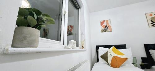 a living room with a mirror and a white couch at Corby Stay 2BR Work Trips & Family Friendly in Corby