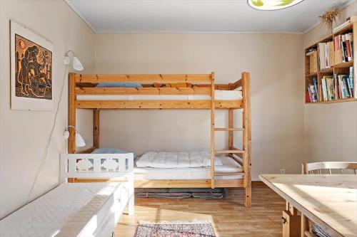 a room with two bunk beds and a desk at TV1360-Bindslev-Munkebakken-5 in Bindslev