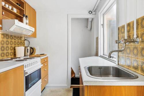a kitchen with a sink and a stove at TV1541-Hirtshals-Hojersgade-19-A in Hirtshals