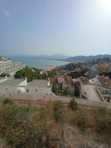 a view of a city with the ocean in the background at LOFT ROYAL - apartamento "loft" con terraza y vistas al mar in Faro de Cullera