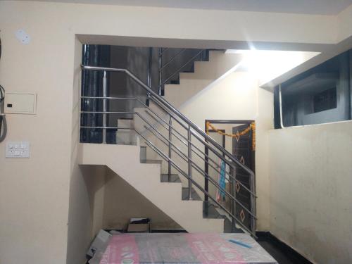a spiral staircase in a building with a bed underneath it at Sri Subramanya pg for ladies in Hyderabad