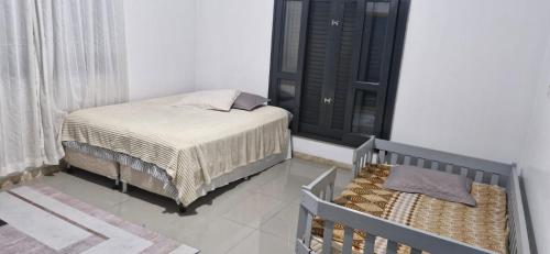 Ένα ή περισσότερα κρεβάτια σε δωμάτιο στο Casa e conforto