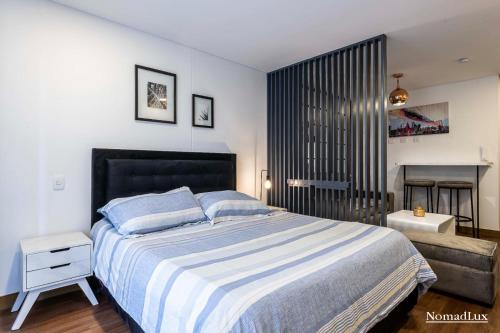 a bedroom with a large bed and a fireplace at Loft estilo Japonés in Bogotá
