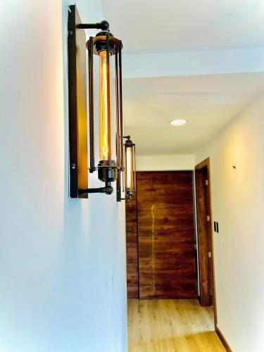 a chandelier hanging on a wall next to a door at Air Stay in Ambato