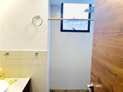 a bathroom with a shower with a window at Air Stay in Ambato
