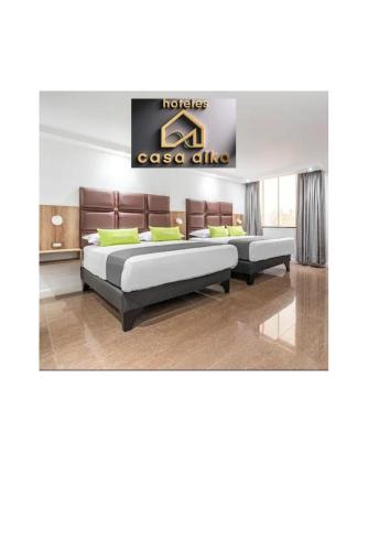 a room with two beds and a sign that reads casos clinic at Hoteles Casa Aika in Lima