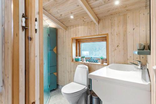 a bathroom with a white toilet and a sink at TV1415-Albaek-Zefyrvej-8 in Ålbæk