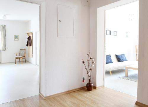 a white room with a door open to a living room at Ferienwohnung Zum Bäckersepp in Neuschönau
