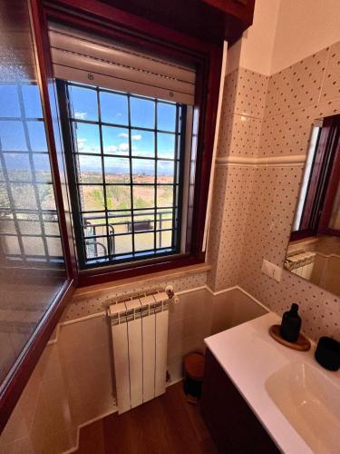 a bathroom with a sink and a large window at La Casa Di Giulia in Rome