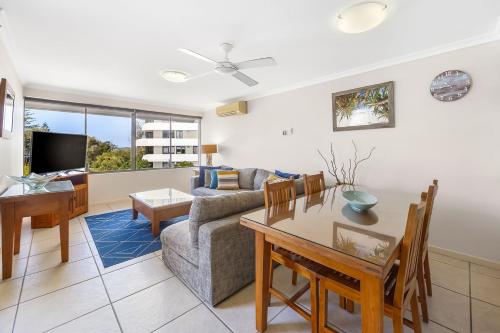 a living room with a couch and a table at Bellardoo Holiday Apartments in Mooloolaba