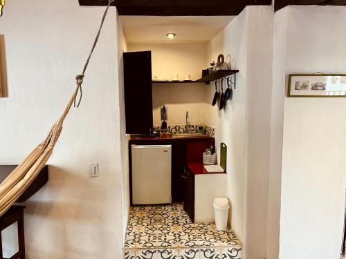a small kitchen with a sink and a refrigerator at Casa Aranjuez in Bogotá