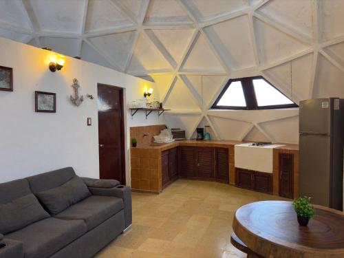 a living room with a couch and a table at House with Pool, Rooftop, Terrace & Bar, AC in Chuburná